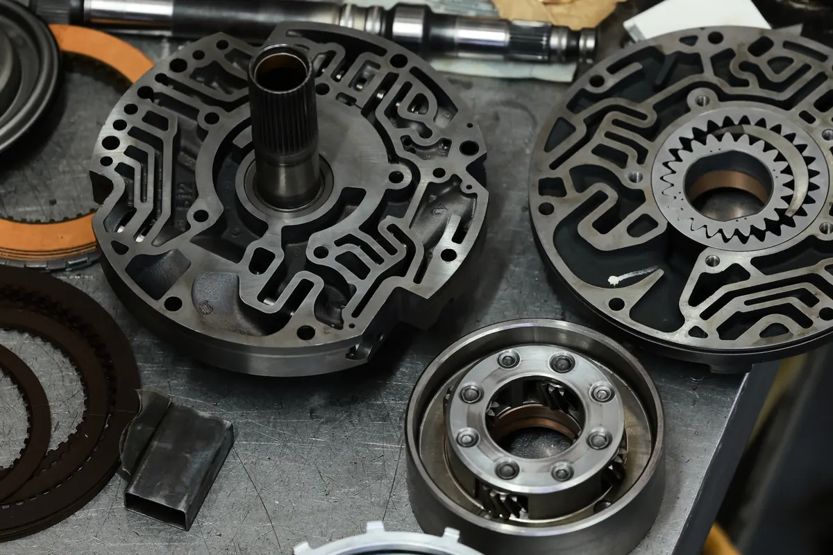 Transmission pump halves and clutch plates on a workbench
