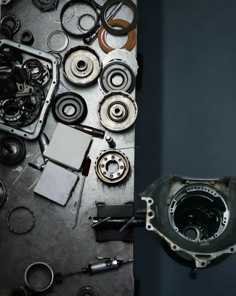 Transmission parts laid out on a workbench, seen from above