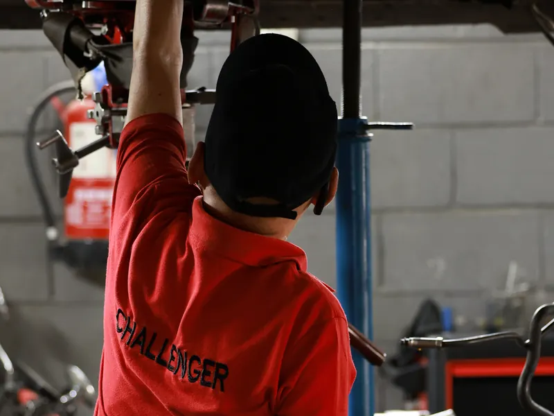 Technician working under a raised vehicle